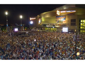 FILE - In this June 2, 2007, file photo, thousands of sports fans pack the plaza between Jacobs Field and Quicken Loans Arena in downtown Cleveland during Game 6 of the NBA basketball Eastern Conference playoff series in Cleveland. A person familiar with the decision says Cleveland's Quicken Loans Arena is being renamed Rocket Mortgage FieldHouse. The announcement of the change will be made Tuesday, April 9, 2019, at a news conference at the home of the NBA's Cavaliers, said the person who spoke Monday night to The Associated Press on condition of anonymity because the team is not revealing the nature of the media gathering.