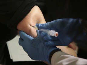 FILE - In this March 27, 2019, file photo, a woman receives a measles, mumps and rubella vaccine at the Rockland County Health Department in Pomona, N.Y. Measles cases in the U.S. this year have climbed to the highest level in 25 years, according to preliminary figures, a resurgence attributed largely to misinformation about vaccines.