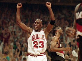FILE - In this June 14, 1992, file photo, Michael Jordan celebrates the Bulls win over the Portland Trail Blazers in the NBA Finals in Chicago. Decades after Jordan's groundbreaking departure from college, March Madness and the NBA's mega-millions have taken all the novelty out of leaving early for the pros.
