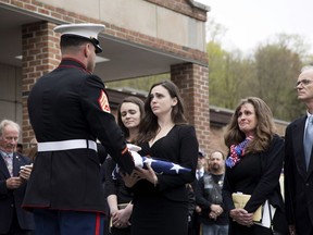Beth Regan is presented with the flag that draped the casket of her friend Marine Private First Class Robert Graham on Friday, April 26, 2019 in Shrub Oak, NY. Graham, who died at 97 has no living family members but Regan arranged for hundreds to attend his funeral. "Receiving the flag was like receiving a part of him," Regan said.