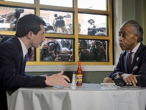 Democratic presidential candidate Mayor Pete Buttigieg, from South Bend, Indiana, and civil rights leader Rev. Al Sharpton, right, President of National Action Network, hold a lunch meeting at Sylvia's Restaurant in Harlem, New York, Monday, April 29, 2019.