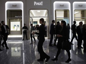 FILE- In this March 14, 2019, file photo people attend the opening of a Piaget store during the opening night of The Shops & Restaurants at Hudson Yards in New York. On Monday, April 1, the Commerce Department releases U.S. retail sales data for February.