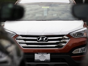 FILE- This Oct. 4, 2012, file photo shows a Hyundai Sonata at a Hyundai car dealership in Des Plaines, Ill.  The U.S. government's highway safety agency said Monday, April 1, 2019, that it has decided to open two new investigations into fires involving Hyundai and Kia vehicles. The investigations cover non-crash fires in almost 3 million vehicles from the affiliated Korean automakers. The probes cover the 2011 through 2014 Hyundai Sonata and Santa Fe, the 2011 through 2014 Kia Optima and Sorento, and the 2010 through 2015 Kia Soul.