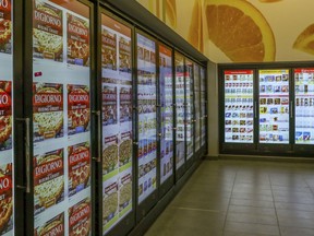 This March 7, 2019, photo shows a smart shelf area at Walgreen's in Chicago. Walgreens, which has more than 8,000 drugstores, installed cooler doors with cameras and sensors at six locations in Chicago, New York, San Francisco and Bellevue, Washington. Instead of the usual clear glass doors that allow customers to see inside, there are video screens that display ads along with the cooler's contents.