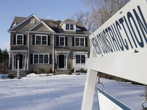 FILE - In this Feb. 21, 2019, file photo a sign is posted near a newly constructed home in Natick, Mass. On Tuesday, April 23, the Commerce Department reports on sales of new homes in March.