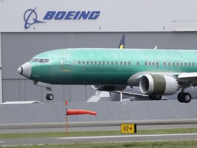 FILE - In this April 10, 2019, file photo a Boeing 737 MAX 8 airplane being built for India-based Jet Airways lands following a test flight at Boeing Field in Seattle. Boeing Co. reports earnings Wednesday, April 24.