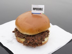FILE- This Jan. 11, 2019, file photo shows the Impossible Burger, a plant-based burger containing wheat protein, coconut oil and potato protein among it's ingredients in Bellevue, Neb. From soy-based sliders to ground lentil sausages, plant-based meat substitutes are surging in popularity. Growing demand for healthier, more sustainable food is one reason people are seeking plant-based meats.