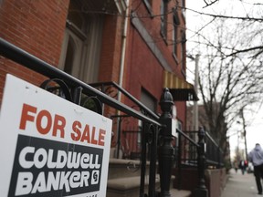 In this Friday, March 29, 2019, photo people walk by an apartment for sale in Jersey City, N.J. On Thursday, April 4, Freddie Mac reports on this week's average U.S. mortgage rates.
