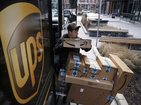 FILE- In this Dec. 19, 2018, file photo a UPS driver prepares to deliver packages. United Parcel Service Inc.  reports earns on Thursday, April 25, 2019.