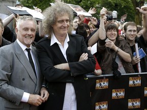 FILE - In this Sept. 13, 2010 file photo,  members of the rock band Queen, Roger Taylor, front left, and Brian May, front right, pose during a meeting with fans to promote the musical "We Will Rock You"  in Berlin, Germany. The musical inspired by the music of Queen is preparing for a North America tour following the popularity of the Academy Award-winning movie, "Bohemian Rhapsody." Producers on Monday, April 1, 2019, announced "We Will Rock You" will open in Winnipeg, Canada, on Sept. 3. Other cities include New York, Los Angeles, Denver and Las Vegas.