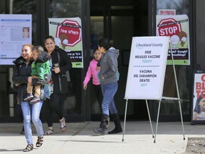 FILE - In this March 27, 2019 file photo, signs advertising free measles vaccines and information about measles are displayed at the Rockland County Health Department, in Pomona, N.Y. U.S. measles cases are continuing to jump, with most of the reported illnesses continuing to be in children. Health officials on Monday, April 8 said 465 measles cases were reported through last week, the second-highest total in 25 years.