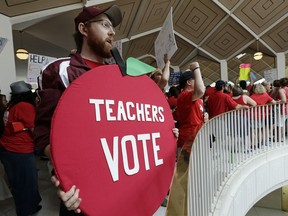 FILE - In this May 16, 2018 file photo, Kevin Poirier, an educator from West Charlotte school, gathers with other educators during a teachers rally at the General Assembly in Raleigh, N.C. North Carolina teachers who are holding their second rally in a year say there's a simple reason why they're doing it: because it works. Educators will gather Wednesday, May 1, 2019, in Raleigh in support of higher pay and other issues. Last year's rally attracted an estimated 20,000 people.