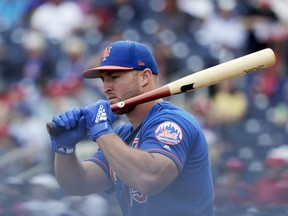 FILE - In this March 7, 2019, file photo, New York Mets' Tim Tebow loosens up before batting in an exhibition spring training baseball game against the Washington Nationals in West Palm Beach, Fla. Tebow is set to begin his third full season of minor league baseball. He was assigned to the Triple-A Syracuse Mets just over two weeks ago and opening day is Thursday, April 4, 2019.