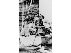 FILE - In this April 21, 1969, file photo, Robin Knox-Johnston waves from the bow of his 32-foot yacht Suhaili as he passes Bishop Rock Lighthouse off the coast of the Isles of Scilly, England. Monday, April 22, 2019, commemorates the 50th anniversary of the finish, when Knox-Johnston achieved the nautical equivalent of climbing Mount Everest when he became the first man to sail alone around the world nonstop. (AP Photo/File)