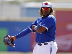 FILE - In this March 6, 2019, file photo, Toronto Blue Jays third baseman Vladimir Guerrero Jr. watches during the second inning of a spring training baseball game against the Philadelphia Phillies in Dunedin, Fla. The Blue Jays top prospect says he feels ready to finally make the jump to the majors, while adding the decision is out of his control. Blue Jays assistant general manager Joe Sheehan said this week the team is still evaluating when to make the move.