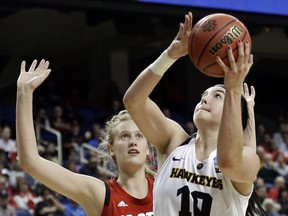 FILE - In this March 30, 2019, file photo, Iowa's Megan Gustafson (10) shoots against North Carolina State's Elissa Cunane (33) during the second half of a regional women's college basketball game in the NCAA Tournament in Greensboro, N.C. Gustafson of Iowa has won the Honda Sports Award as the top woman in college basketball. Gustafson led Division I women's basketball with an average of 28 points this season.