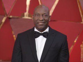 FILE - This March 4, 2018 file photo shows John Singleton at the Oscars in Los Angeles. The family for Singleton says the filmmaker will be taken off life support Monday, April 29, 2019, after suffering a stroke almost two weeks ago. In a statement Monday, Singleton's family said it was "an agonizing decision, one that our family made over a number of days with the careful counsel of John's doctors."