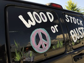 FILE - This Aug. 14, 2009 file photo shows a van decorated with "Woodstock or Bust" at the original Woodstock Festival site in Bethel, N.Y.  Woodstock 50 is proving to be as chaotic as the original festival held in 1969. A financial investor in the festival announced Monday, April 29, 2019, it was pulling its funding from the anniversary event, set to take place Aug. 16-18 in Watkins Glen, N.Y.