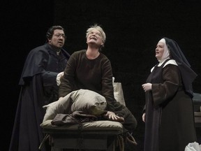 This image released by the Metropolitan Opera shows soprano Karita Mattila, center, Paul Corona, left, and Karen Cargill during a performance of Poulenc's "Dialogues of the Carmelites" at the Metropolitan Opera in New York.