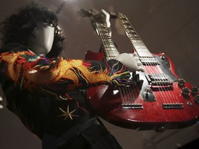 This April 1, 2019 file photo shows a double-neck guitar played by Jimmy Page of Led Zeppelin displayed at the exhibit "Play It Loud: Instruments of Rock & Roll," at the Metropolitan Museum of Art in New York. The exhibit, which showcases the instruments of rock and roll legends, runs until Oct. 1, 2019.