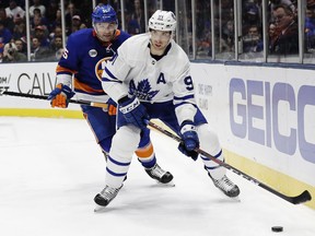 Toronto Maple Leafs' John Tavares (91) looks to pass away from New York Islanders' Johnny Boychuk (55) during the first period of an NHL hockey game Monday, April 1, 2019, in Uniondale, N.Y.
