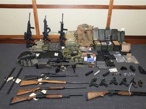 FILE - This undated file image provided by the U.S. District Court in Maryland shows a photo of firearms and ammunition that was in the motion for detention pending trial in the case against Christopher Hasson. A federal magistrate agreed on Thursday, April 25, 2019, to order the pretrial release of the Coast Guard lieutenant accused of creating a hit list of prominent Democrats, Supreme Court justices, network TV journalists and social media company executives. (U.S. District Court via AP, File)
