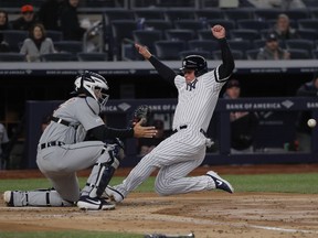 New York Yankees' Luke Voit beats the throw home to Detroit Tigers catcher Grayson Greiner to score on a hit to left field and a fielding error by Detroit Tigers left fielder Christin Stewart during the third inningof a baseball game, Monday, April 1, 2019, in New York.