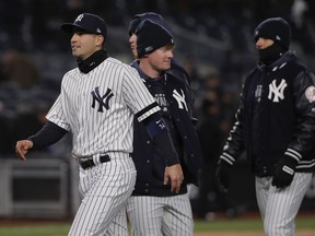New York Yankees' Tyler Wade, left, celebrates with teammates after the Yankees beat the Detroit Tigers 3-2 in a baseball game, Monday, April 1, 2019, in New York. Wade was recalled from Scranton after Miguel Andujar was put on the 10-day injured list with a right shoulder strain.