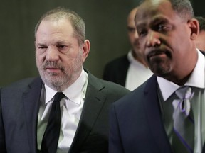 FILE - In this Jan. 25, 2019, file photo, Harvey Weinstein, left, leaves court with attorney Ron Sullivan in New York. Both sides in Harvey Weinstein's sexual assault case want the media and the public barred from the disgraced movie mogul's next court appearance. News organizations including Thee Associated Press are fighting to keep the hearing open plan to file a petition Monday, April 22, with the court.