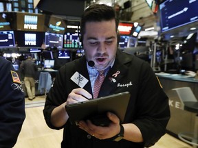 FILE - In this March 18, 2019, file photo trader Joseph Lawler works on the floor of the New York Stock Exchange. The U.S. stock market opens at 9:30 a.m. EDT on Tuesday, April 30.