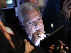 FILE - In this April 11, 2019, file photo trader Peter Castelli works on the floor of the New York Stock Exchange. The U.S. stock market opens at 9:30 a.m. EDT on Thursday, April 18.