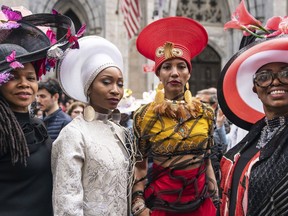 Participants wearing costumes and hats poses for a photo during the Easter Parade and Bonnet Festival, Sunday, April 21, 2019 in New York.