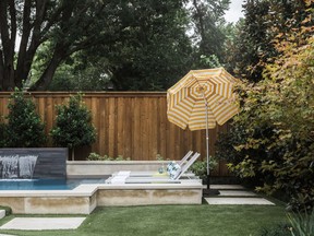 This undated photo shows a home in Texas' backyard area designed by Abbe Fenimore, founder of Studio Ten 25. The seating around backyard swimming pools is often located in direct sunlight, so Fenimore suggests using large, durable and easily positioned umbrellas to allow guests to control their sun exposure.