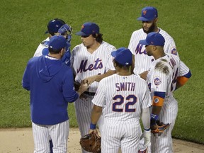 New York Mets starting pitcher Jason Vargas hands the ball to manager Mickey Callaway, left, as he leave the game during the fifth inning of a baseball game Wednesday, April 24, 2019, in New York.