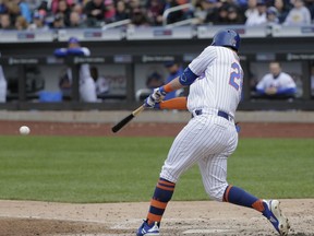 New York Mets' J.D. Davis hits an RBI-single during the seventh inning of a baseball game against the Milwaukee Brewers at Citi Field, Sunday, April 28, 2019, in New York.