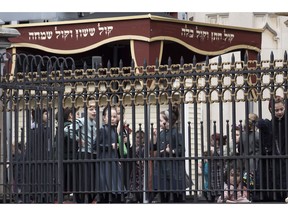 Girls play in a yeshiva schoolyard, Tuesday, April 9, 2019, in the Williamsburg section of New York. The city health department ordered all ultra-Orthodox Jewish schools in a neighborhood of Brooklyn on Monday to exclude unvaccinated students from classes during the current measles outbreak. In issuing the order, the health department said that any yeshiva in Williamsburg that does not comply will face fines and possible closure.