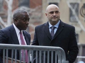 Craig Carton, right, the former co-host of a sports radio show with ex-NFL quarterback Boomer Esiason, arrives at federal court to be sentenced for defrauding investors in a ticket reselling business, Friday, April 5, 2019, in New York.