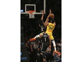 Brooklyn Nets center Jarrett Allen (31) attempts to block Milwaukee Bucks forward Giannis Antetokounmpo (34) during the first half of an NBA basketball game, Monday, April 1, 2019, in New York.