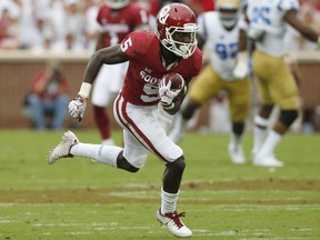 FILE - In this Sept. 8, 2018, file photo, Oklahoma wide receiver Marquise Brown (5) carries during an NCAA college football game against UCLA, in Norman, Okla. Brown is a possible pick in the 2019 NFL Draft.