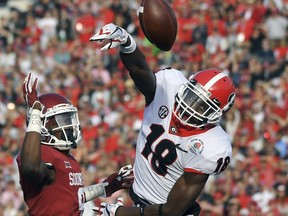 FILE - In this Monday, Jan. 1, 2018, file photo, Georgia defensive back Deandre Baker (18) breaks up a pass intended for Oklahoma wide receiver CeeDee Lamb, left, during the first half of the Rose Bowl NCAA college football game in Pasadena, Calif. Baker is a possible pick in the 2019 NFL Draft.