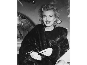 FILE - In this undated file photo, actress Marilyn Monroe smiles in a car after arriving at Idlewild Airport in New York. Lawmakers are pushing a measure that would ban the sale of all new fur products in the city. This, in a town where such garments were once common and style-setters including Marilyn Monroe, Jacqueline Kennedy Onassis, Joe Namath and Sean "Diddy" Combs have all rocked furs over the years.