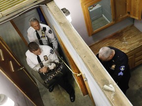 New York City Police Dept. Chief Robert Lukach, background center, and Capt. Ronald Zedalis, left, negotiate with Sgt. Kenneth O'Brien portraying a barricaded person during a tactical demonstration at New York City Emergency Service Unit headquarters at Floyd Bennett Field in New York, on Thursday, March 28, 2019.