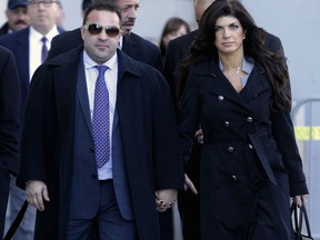 FILE - In this Nov. 20, 2013, file photo, Giuseppe "Joe" Giudice, left, and his wife, Teresa Giudice, of Montville Township, N.J., walk out of Martin Luther King Jr. Courthouse after a court appearance, in Newark, N.J. On Thursday, April 18, 2019, attorneys for Joe Giudice said that their client has lost his appeal to avoid deportation to Italy.