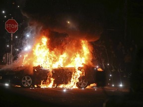 A car burns after petrol bombs were thrown at police in the Creggan area of Londonderry, in Northern Ireland.