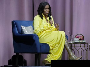 This This Dec. 19, 2018, file photo shows former first lady Michelle Obama speaking as she is interviewed by Sarah Jessica Parker during an appearance in New York. Obama, Conan O'Brien, Kelly Rowland, Bebe Rexha, Jesse Williams, Usher, Pentatonix, La La Anthony, Don Cheadle, and other entertainers and athletes are slated to gather on the UCLA campus on May 1 to commemorate the day that high school students choose to pursue higher education. Events also are planned throughout the U.S. This will mark Obama's sixth college signing day that she has celebrated with Reach Higher. As first lady, Obama used the Reach Higher Initiative to inspire high school students to continue their education by attending college, a training program, or joining the military.