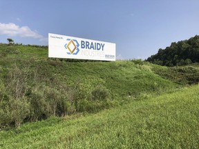 File-This Aug. 22, 2018, file photo shows a sign declaring the future home of Braidy Industries' aluminum mill in Ashland, Ky. An aluminum company planning to build a $1.7 billion plant in Appalachia is forming a partnership with a Russian company that until recently faced U.S. sanctions. Russian aluminum giant Rusal wants to invest $200 million in an aluminum rolling mill that Braidy Industries intends to build near Ashland, Kentucky. Rusal says it would assume a 40 percent ownership share in the mill in return for the investment. Braidy Industries would hold the other 60 percent share.