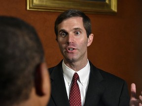 FILE - In a Thursday, Sept. 20, 2018 file photo, Kentucky Attorney General Andy Beshear answers a reporters' question following his presentation to the Supreme Court at the Kentucky Capitol in Frankfort, Ky. says it disagrees with Kentucky's Democratic attorney general over the validity of a state law that could determine if the state's only abortion clinic stays open. The disagreement stems from a legal brief filed by Attorney General Beshear in support of the clinic, EMW Women's Surgical Center in Louisville.