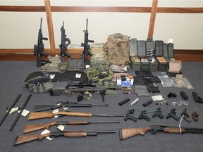 FILE - This file image provided by the U.S. District Court in Maryland shows a photo of firearms and ammunition that was in the motion for detention pending trial in the case against Christopher Paul Hasson. Hasson, a Coast Guard lieutenant accused of stockpiling guns and compiling a hit list of prominent Democrats and network TV journalists looked at other targets: two Supreme Court justices and two executives of social media companies, according to federal prosecutors  in a court filing Tuesday, April 22, 2019.
