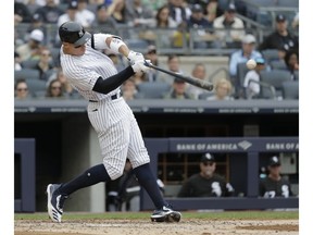 New York Yankees' Aaron Judge hits an RBI single during the third inning of a baseball game against the Chicago White Sox, Sunday, April 14, 2019, in New York.