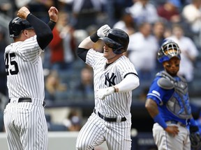 New York Yankees' Clint Frazier, center, celebrates his three-run home run with Yankees' Luke Voit (45) in front of Kansas City Royals catcher Martin Maldonado during the fifth inning of a baseball game against the Kansas City Royals on Sunday, April 21, 2019, in New York.